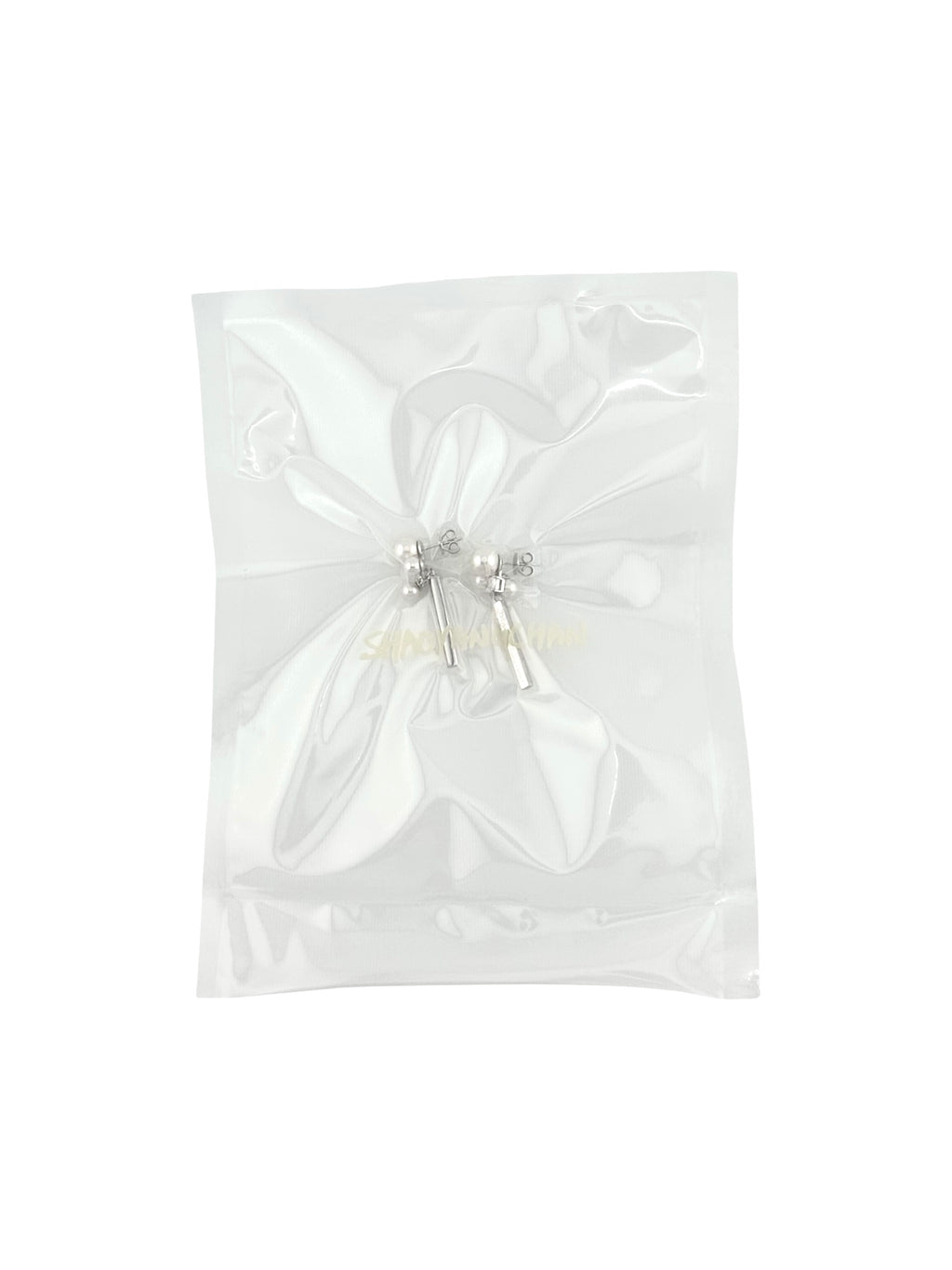 A pair of silver and pearl earrings in an anti-tarnish plastic packaging.