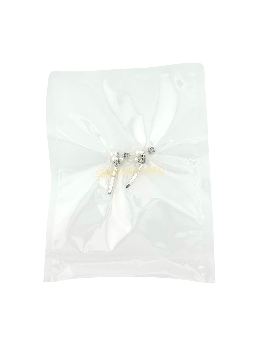 A pair of silver and pearl earrings packaged in a clear plastic bag.